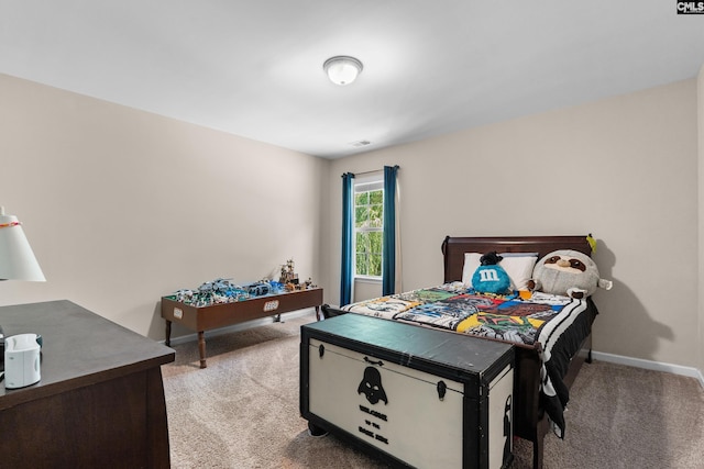 bedroom featuring light colored carpet and baseboards
