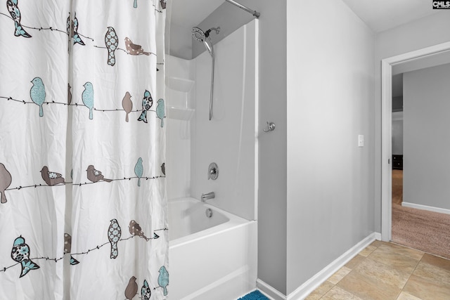 bathroom featuring baseboards and shower / bath combination with curtain