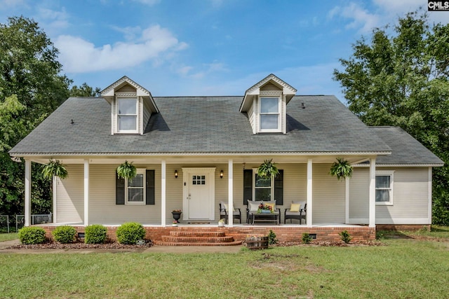 view of front of property featuring covered porch and a front lawn