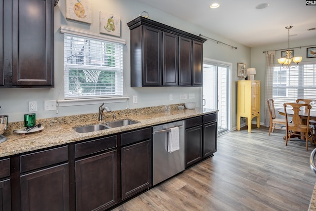 kitchen with dishwasher, a sink, light wood finished floors, dark brown cabinetry, and recessed lighting