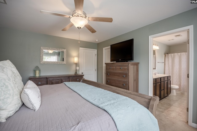 bedroom featuring ensuite bath and ceiling fan