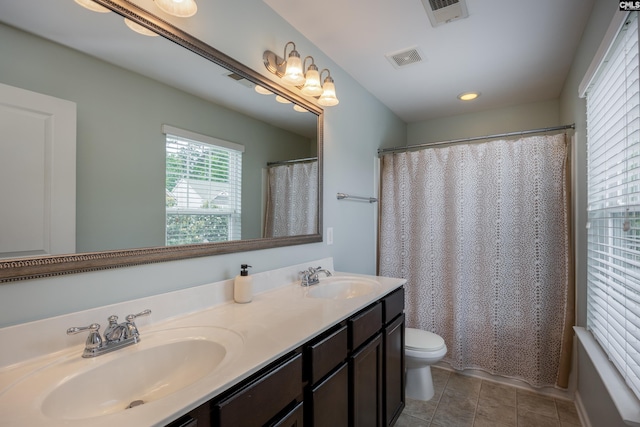 bathroom featuring toilet, double vanity, tile patterned floors, recessed lighting, and a shower with curtain