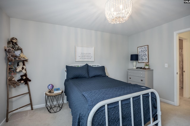 bedroom with light colored carpet, a chandelier, and baseboards