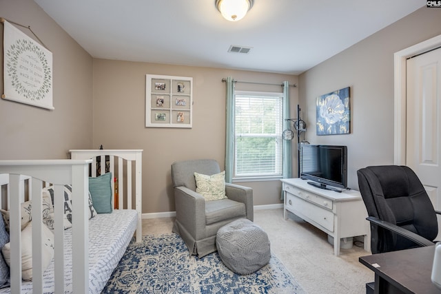 bedroom featuring light colored carpet, baseboards, and an office area