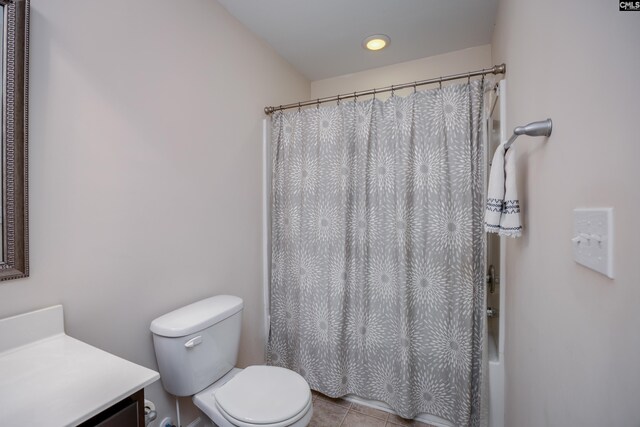bathroom featuring toilet, vanity, a shower with curtain, and tile patterned floors