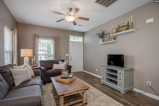 living room with a ceiling fan, wood finished floors, and baseboards