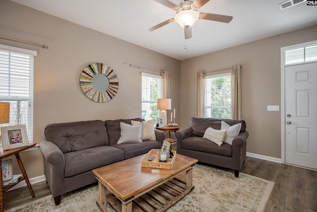 living room with wood finished floors, baseboards, and a ceiling fan
