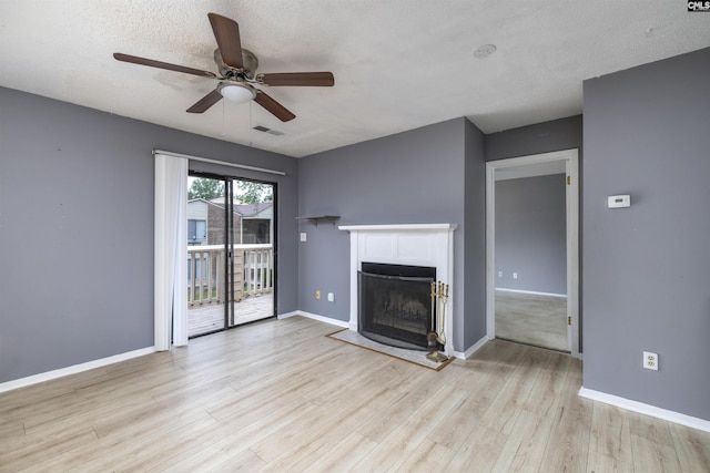 229 Windsor Point Rd Unit 7-D, Columbia, SC 29223 - unfurnished living room with ceiling fan, a fireplace, baseboards, wood finished floors, and a textured ceiling