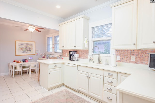 kitchen featuring a sink, dishwasher, light tile patterned floors, backsplash, and ornamental molding