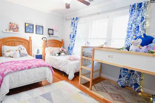 bedroom featuring wood finished floors, ornamental molding, and ceiling fan