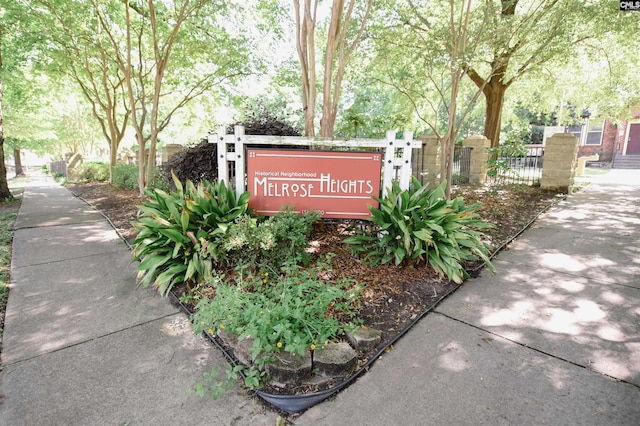 community sign featuring fence