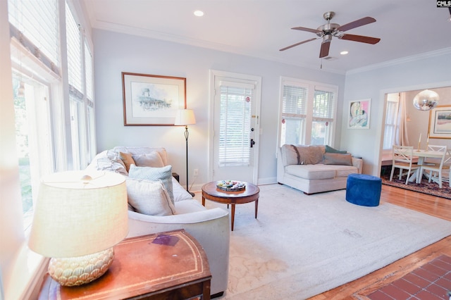 living room featuring ornamental molding, a ceiling fan, wood finished floors, recessed lighting, and baseboards