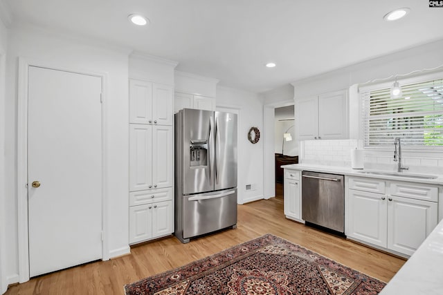 1148 Eastminster Dr, Columbia, SC 29204 - kitchen with stainless steel appliances, a sink, light wood-style flooring, white cabinets, and recessed lighting
