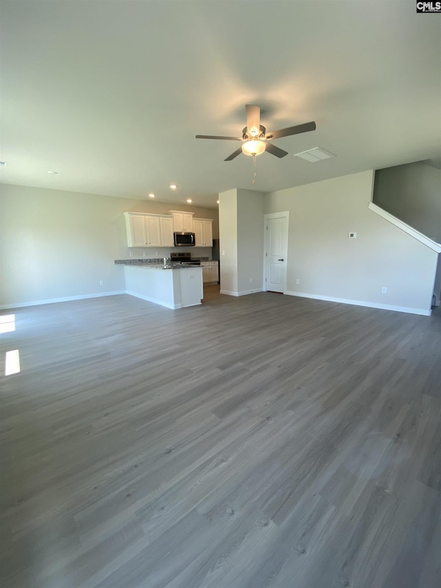 unfurnished living room with baseboards, wood finished floors, recessed lighting, and ceiling fan