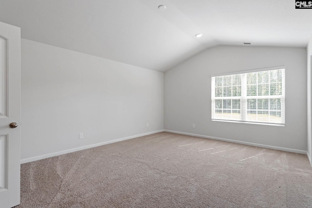 bonus room featuring lofted ceiling, carpet floors, and baseboards