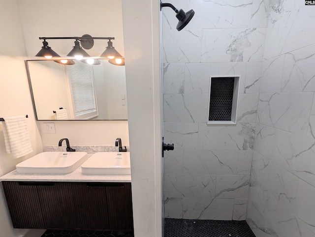 bathroom featuring tiled shower and double vanity