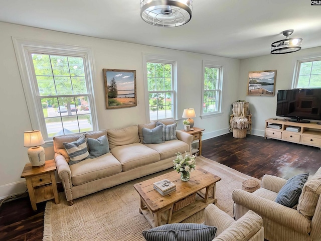 living area with wood finished floors and baseboards