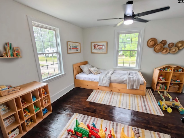 bedroom featuring wood finished floors, baseboards, and ceiling fan