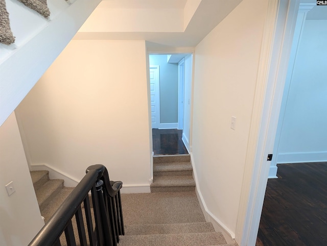 stairs featuring baseboards and wood finished floors