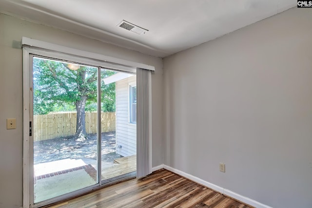 entryway with wood finished floors and baseboards