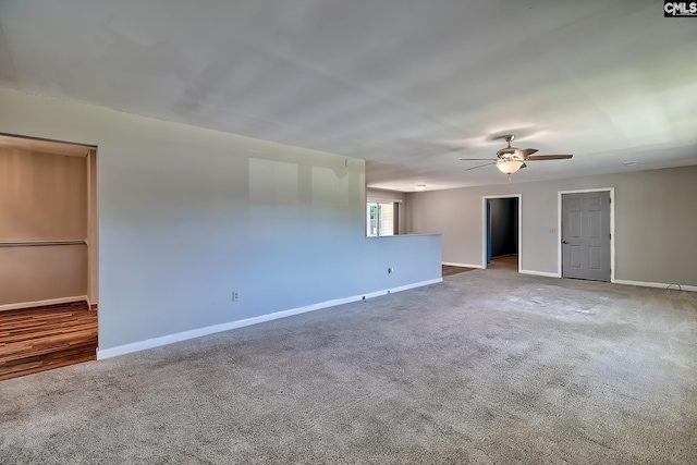spare room featuring a ceiling fan, baseboards, and carpet flooring