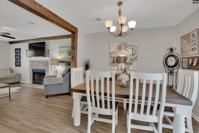 117 Rosewood Ln, Lexington, SC 29072 - dining area featuring wood finished floors, a chandelier, a fireplace, and ceiling fan