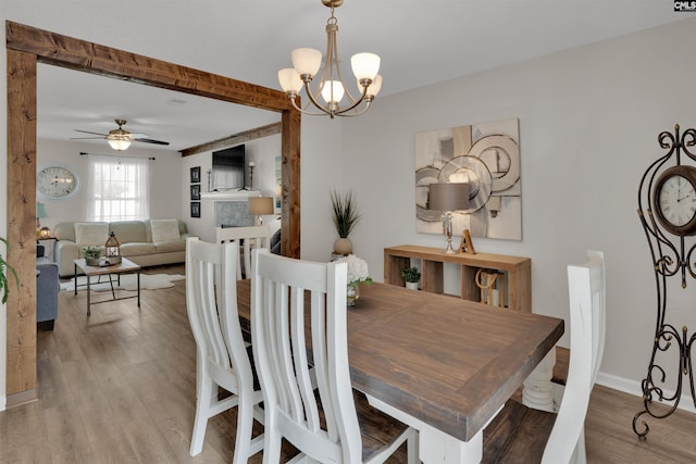 117 Rosewood Ln, Lexington, SC 29072 - dining area with wood finished floors, a chandelier, a ceiling fan, and baseboards