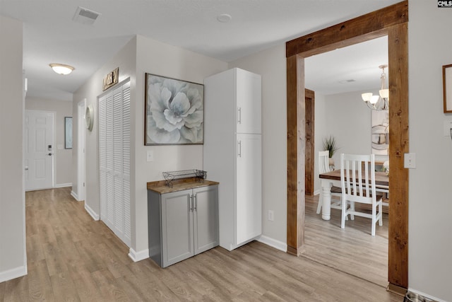 117 Rosewood Ln, Lexington, SC 29072 - hallway featuring light wood-type flooring, a chandelier, and baseboards