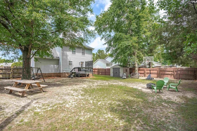 117 Rosewood Ln, Lexington, SC 29072 - view of yard with a fire pit, a storage unit, an outdoor structure, and a wooden deck