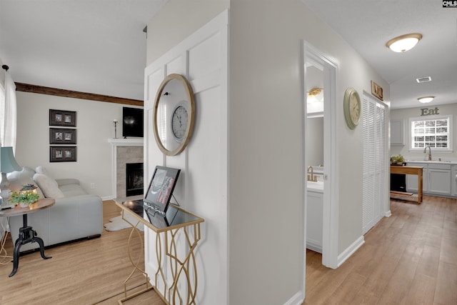 117 Rosewood Ln, Lexington, SC 29072 - hallway featuring light wood-style floors, a sink, and baseboards