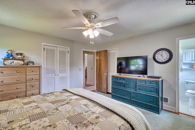 bedroom with two closets, connected bathroom, a ceiling fan, carpet, and baseboards