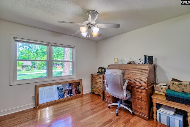 office area with wood finished floors, a ceiling fan, baseboards, and a textured ceiling