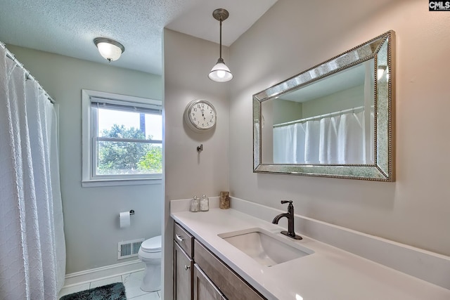 bathroom with toilet, vanity, tile patterned flooring, and baseboards