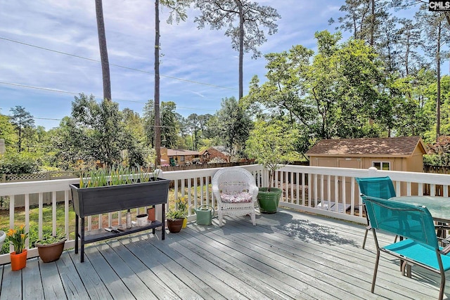 wooden terrace featuring an outbuilding
