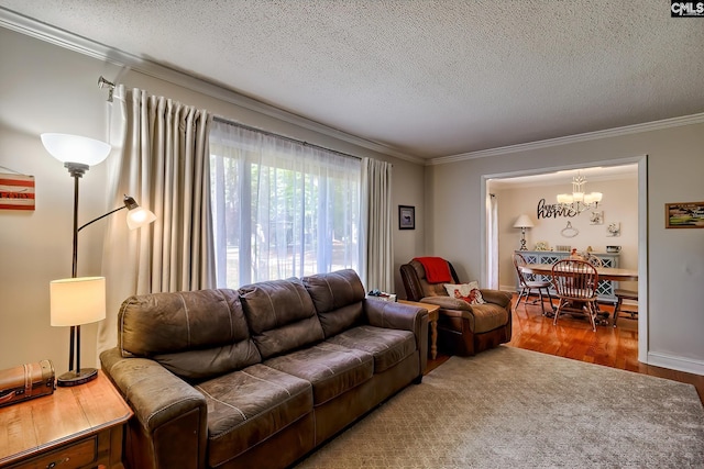 living area with ornamental molding, a chandelier, a textured ceiling, and wood finished floors