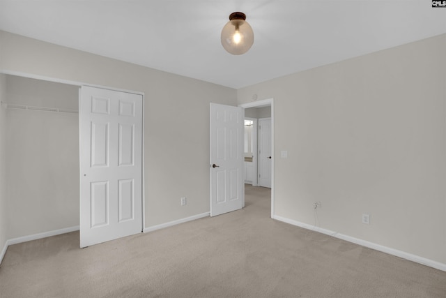 unfurnished bedroom with carpet floors, baseboards, and a closet
