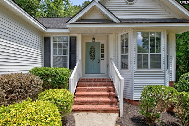property entrance with roof with shingles