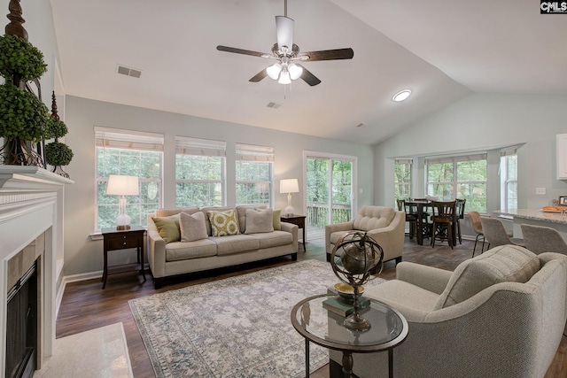 living area featuring wood finished floors, ceiling fan, a fireplace with flush hearth, recessed lighting, and baseboards