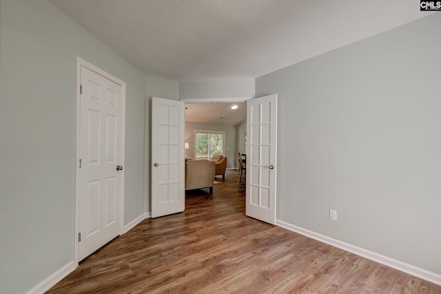 unfurnished bedroom featuring wood finished floors and baseboards