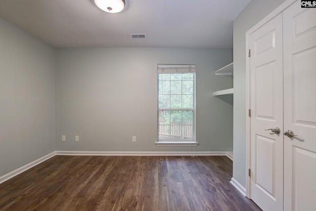 laundry room with dark wood finished floors and baseboards