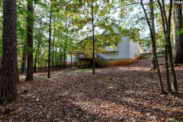 view of yard featuring fence and stairs