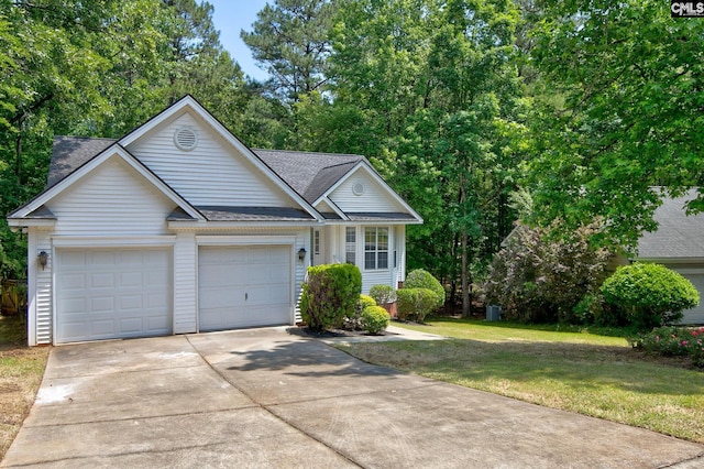 view of front of home featuring concrete driveway, a shingled roof, an attached garage, and a front lawn