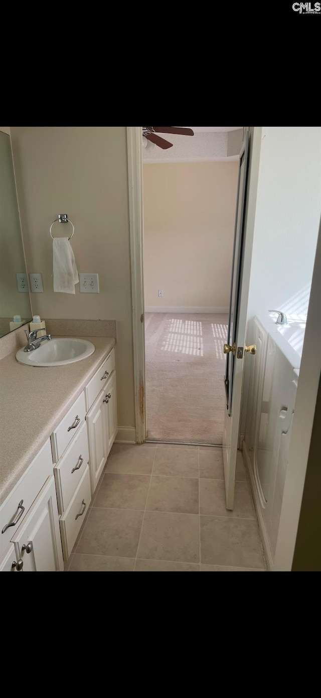 bathroom with ceiling fan, vanity, and tile patterned flooring