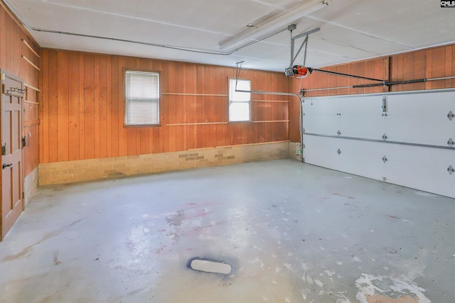 garage featuring wooden walls and a garage door opener