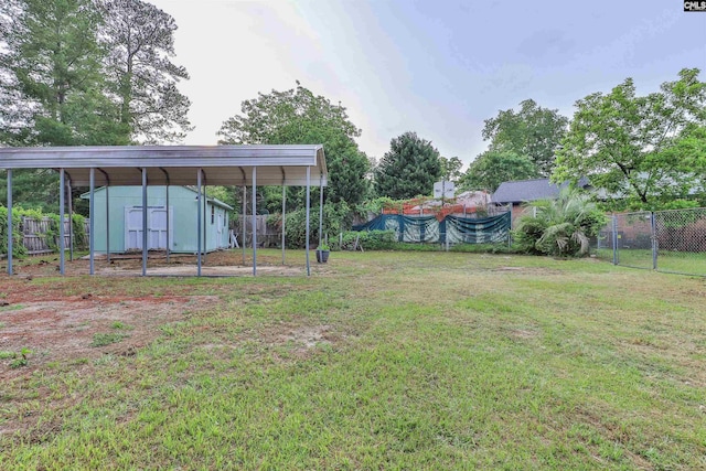 view of yard with a storage shed, a carport, and an outdoor structure