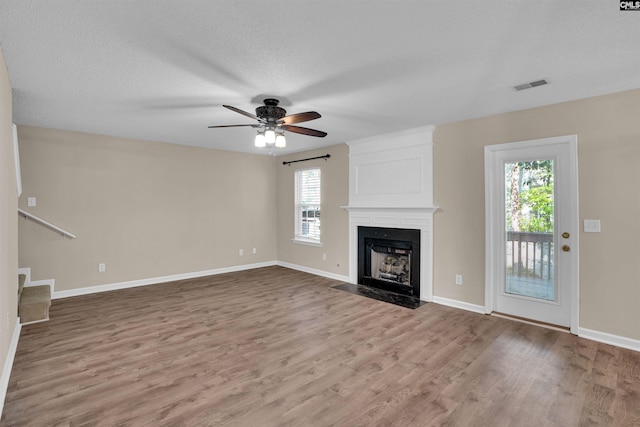 103 Beacon Ln, Columbia, SC 29229 - unfurnished living room with plenty of natural light, wood finished floors, a fireplace, and a textured ceiling
