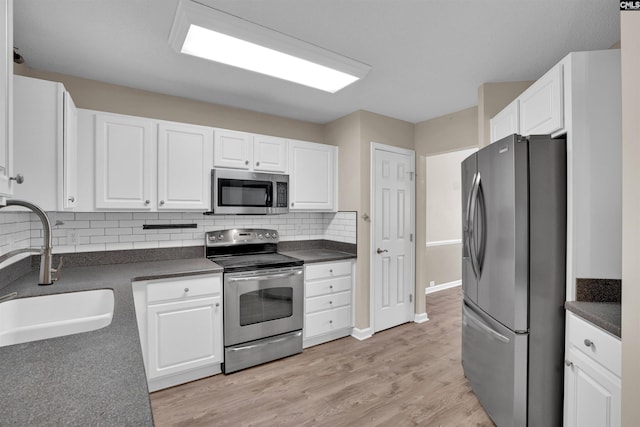 103 Beacon Ln, Columbia, SC 29229 - kitchen featuring appliances with stainless steel finishes, a sink, dark countertops, and white cabinets
