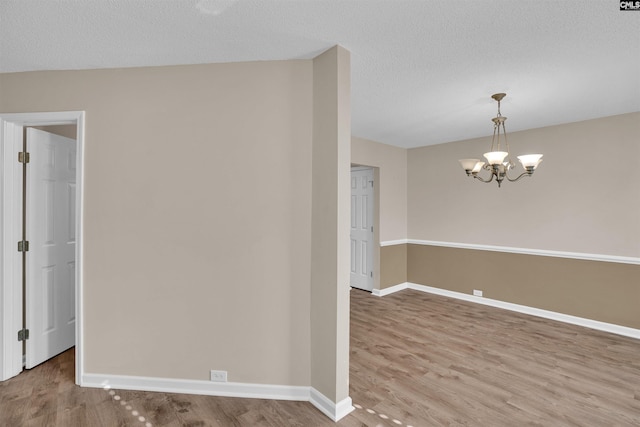 103 Beacon Ln, Columbia, SC 29229 - unfurnished room with baseboards, a chandelier, wood finished floors, and a textured ceiling