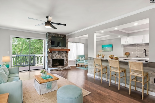 284 Outrigger Ln, Columbia, SC 29212 - living room featuring crown molding, ceiling fan, dark wood finished floors, a stone fireplace, and recessed lighting