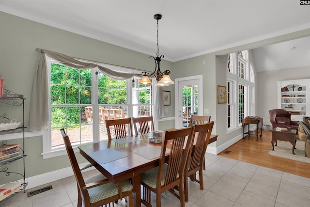 17 Laurel Bluff Ct, Columbia, SC 29229 - dining space with healthy amount of natural light, a chandelier, light tile patterned floors, ornamental molding, and baseboards